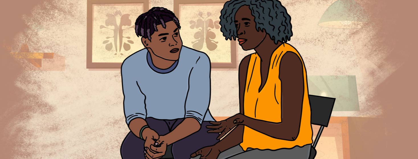 Young adult African American male and older adult African American woman sit in therapy session